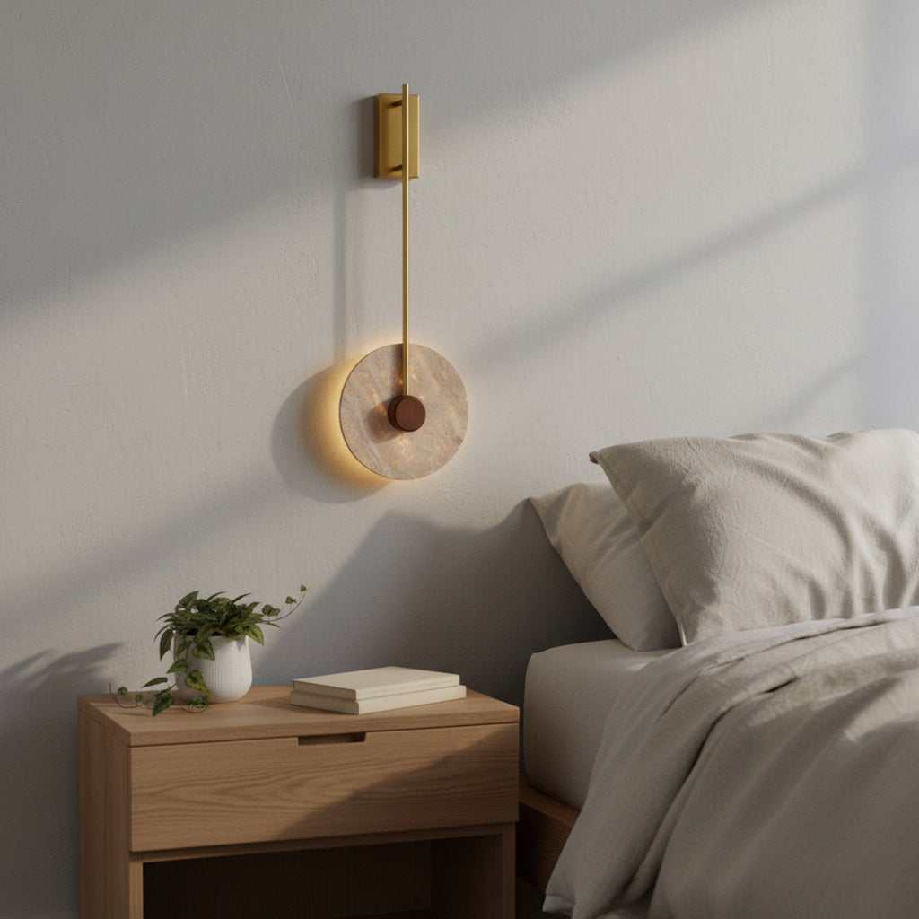 Veil Travertine Wall Lamp above nightstand in bedroom